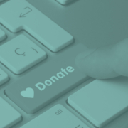 Finger pressing donate button on keyboard